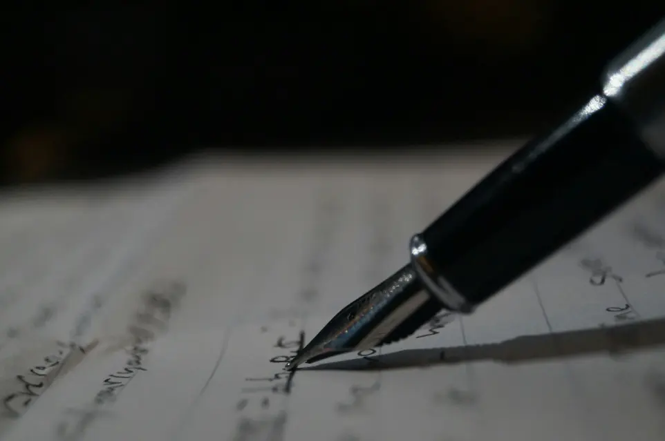 a pen is sitting on top of a piece of paper